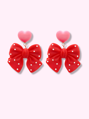 Polka Heart Bow Earrings in red with pink heart accents.