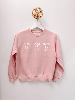 Blushing Bow Kids Crewneck blush pink sweatshirt with three white bow accents; Sassy Shortcake design.