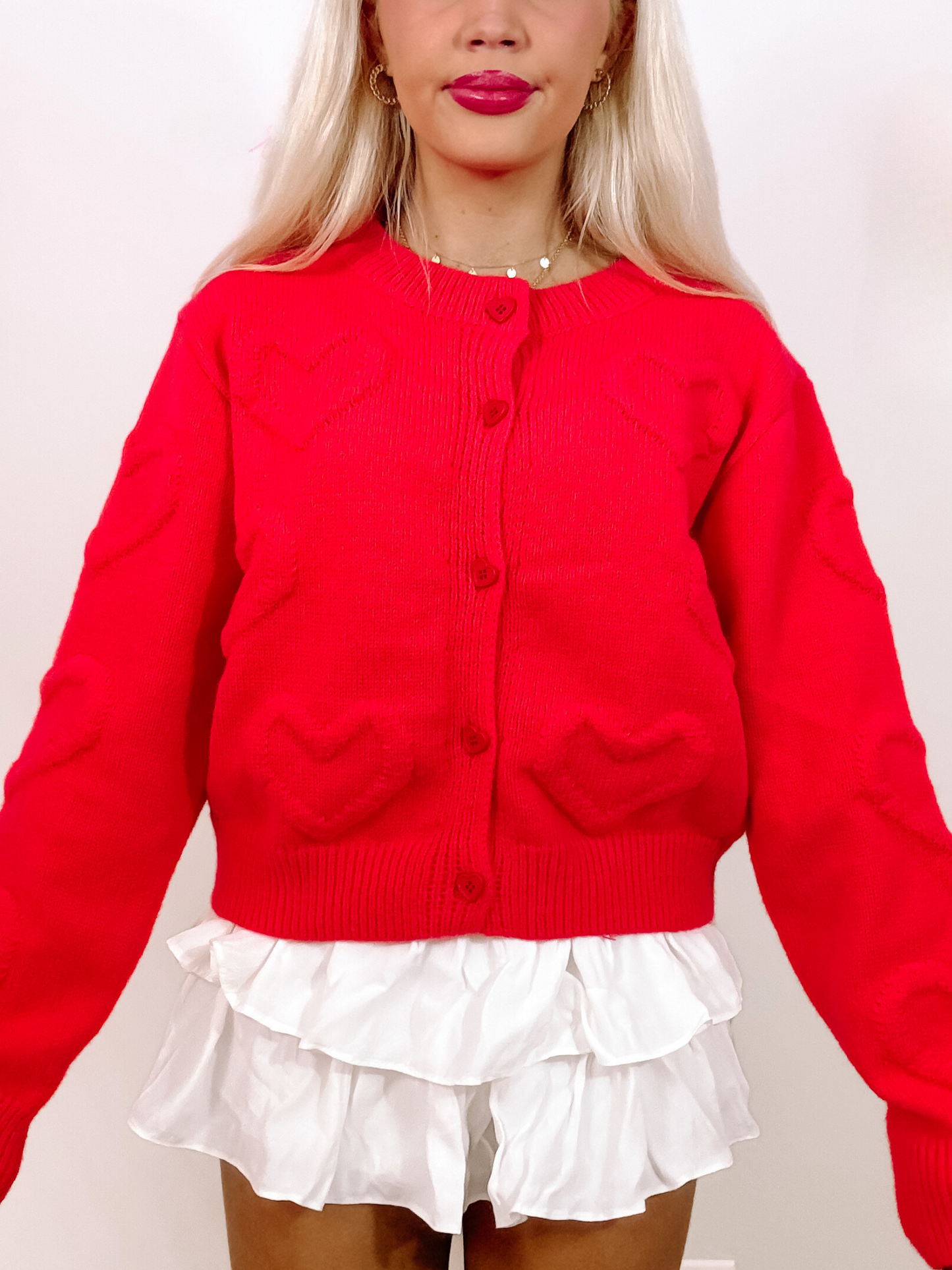 Red cable knit Falling Hearts cardigan with heart-shaped detailing