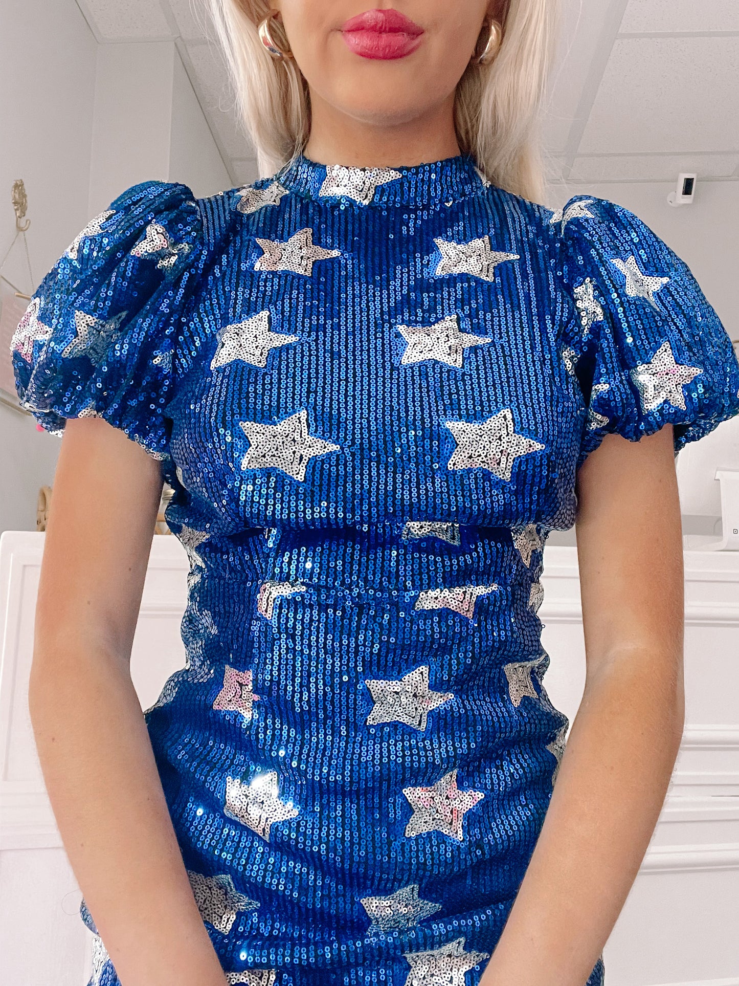 Sequined mini dress; bright blue with silver stars, puff sleeves.
