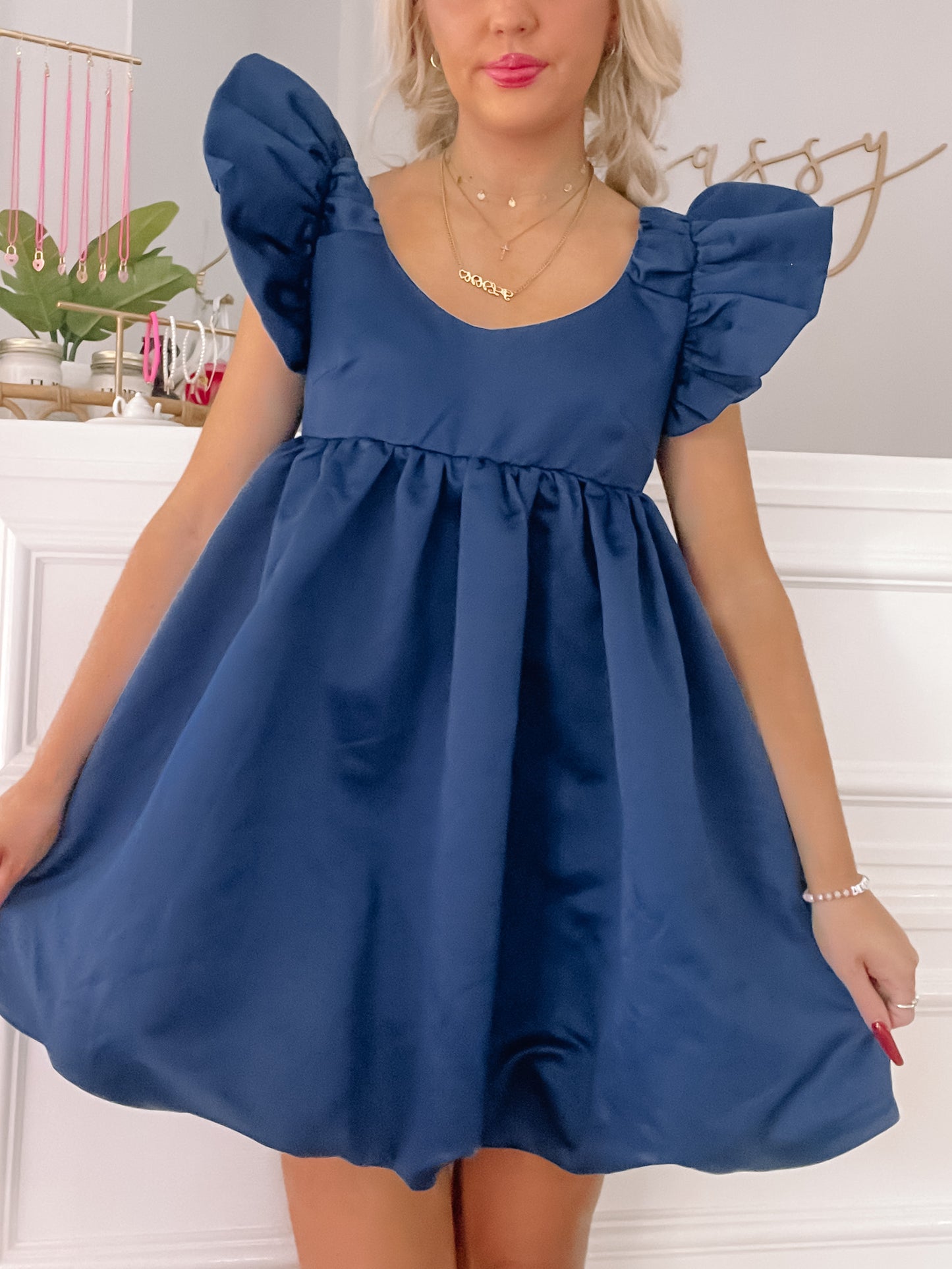 Navy blue fit-and-flare mini dress with puffed sleeves, shown on a model.