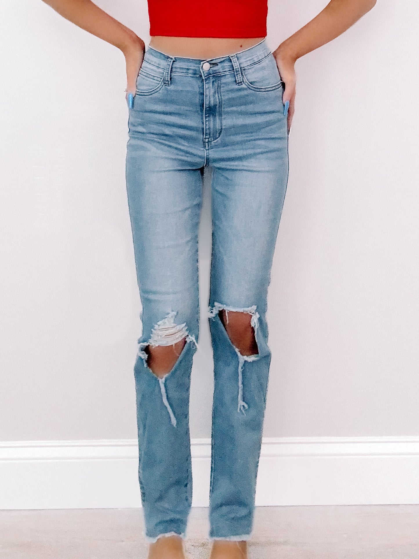 Light wash Rylan jeans with distressed knees and a straight leg fit.