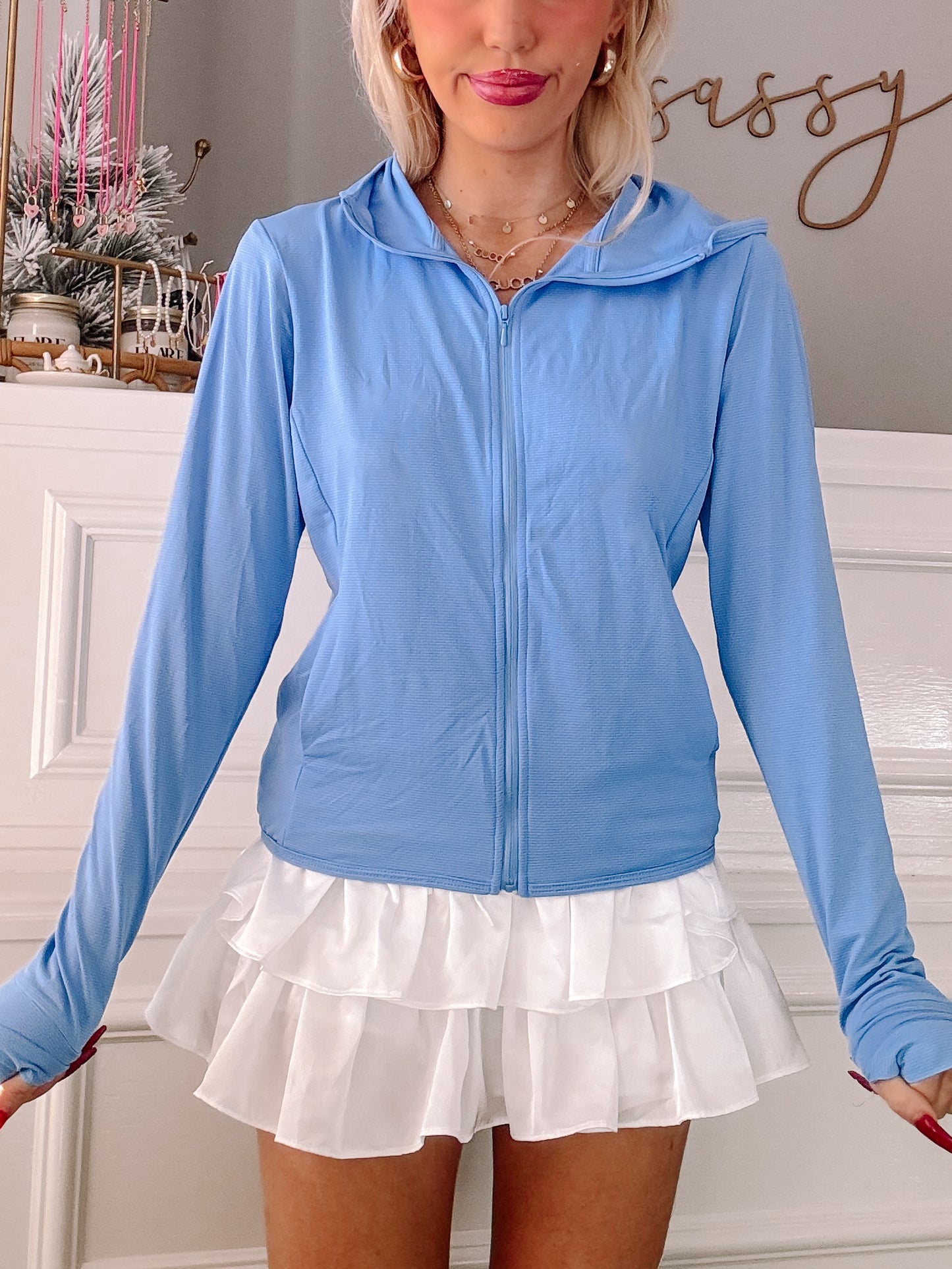 Light blue zip-up jacket with long sleeves and thumbholes.