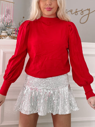 Red Marnie sweater with puff sleeves.