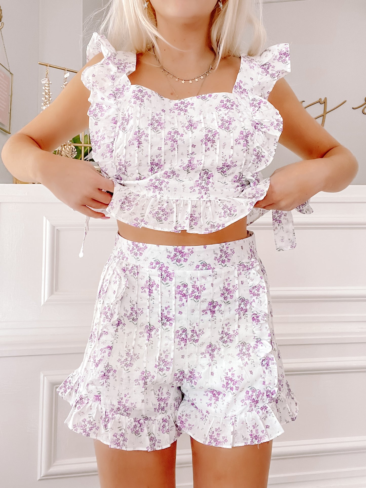 Linen lilac floral print two-piece set; ruffle trim on the cropped top and shorts.
