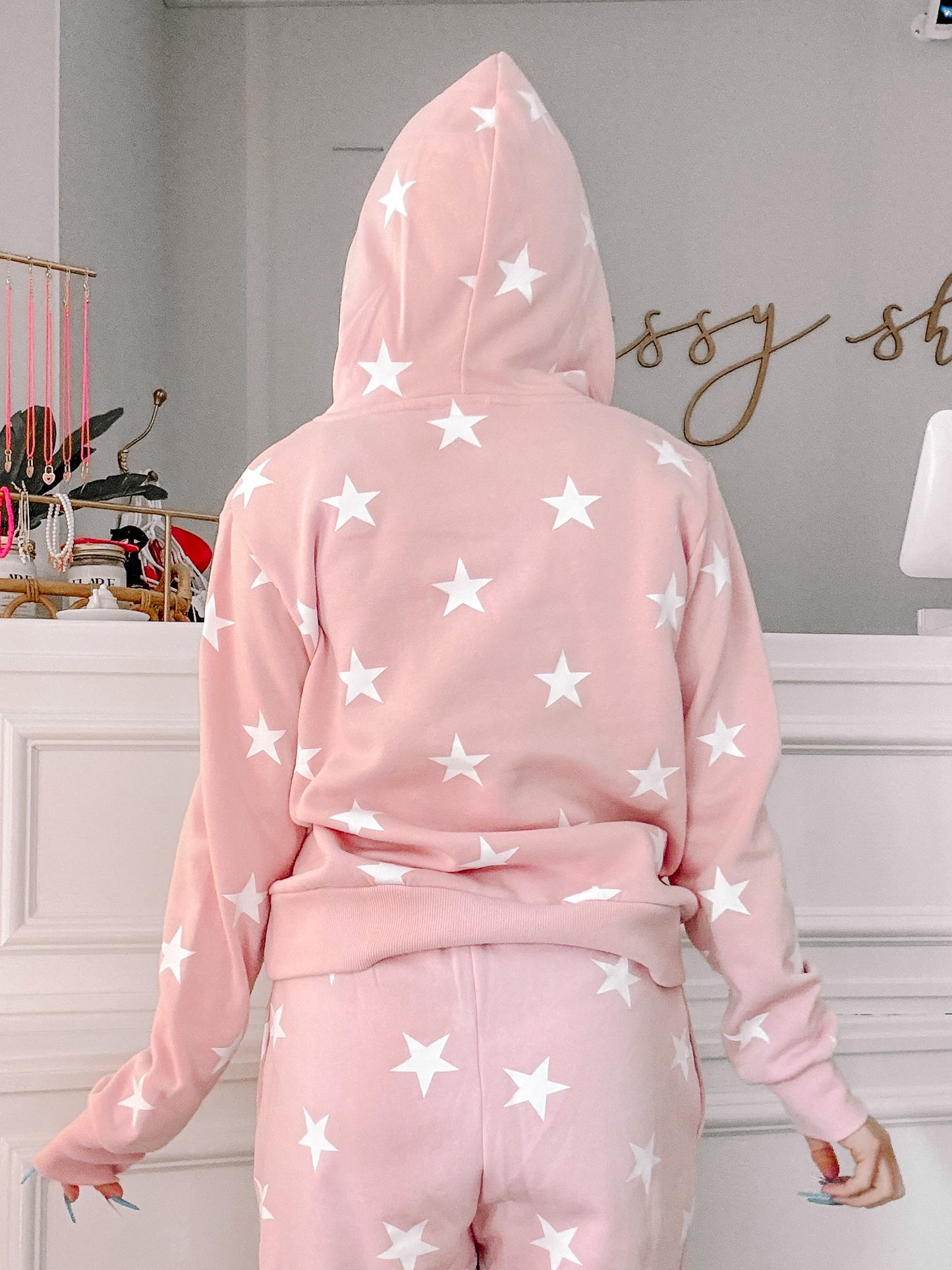 Pink hoodie and sweatpants set with white star pattern, shown from the back.