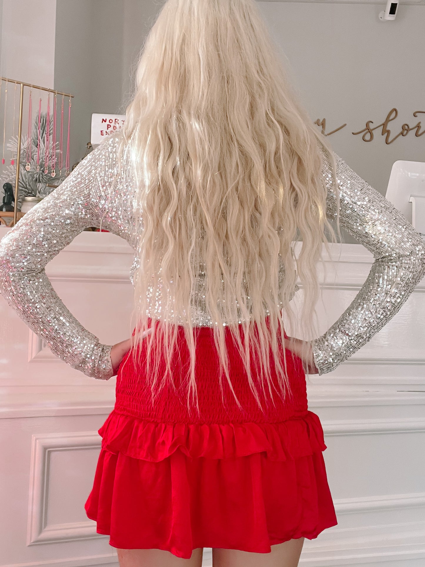 Red ruffled mini skirt paired with a silver sequined top.