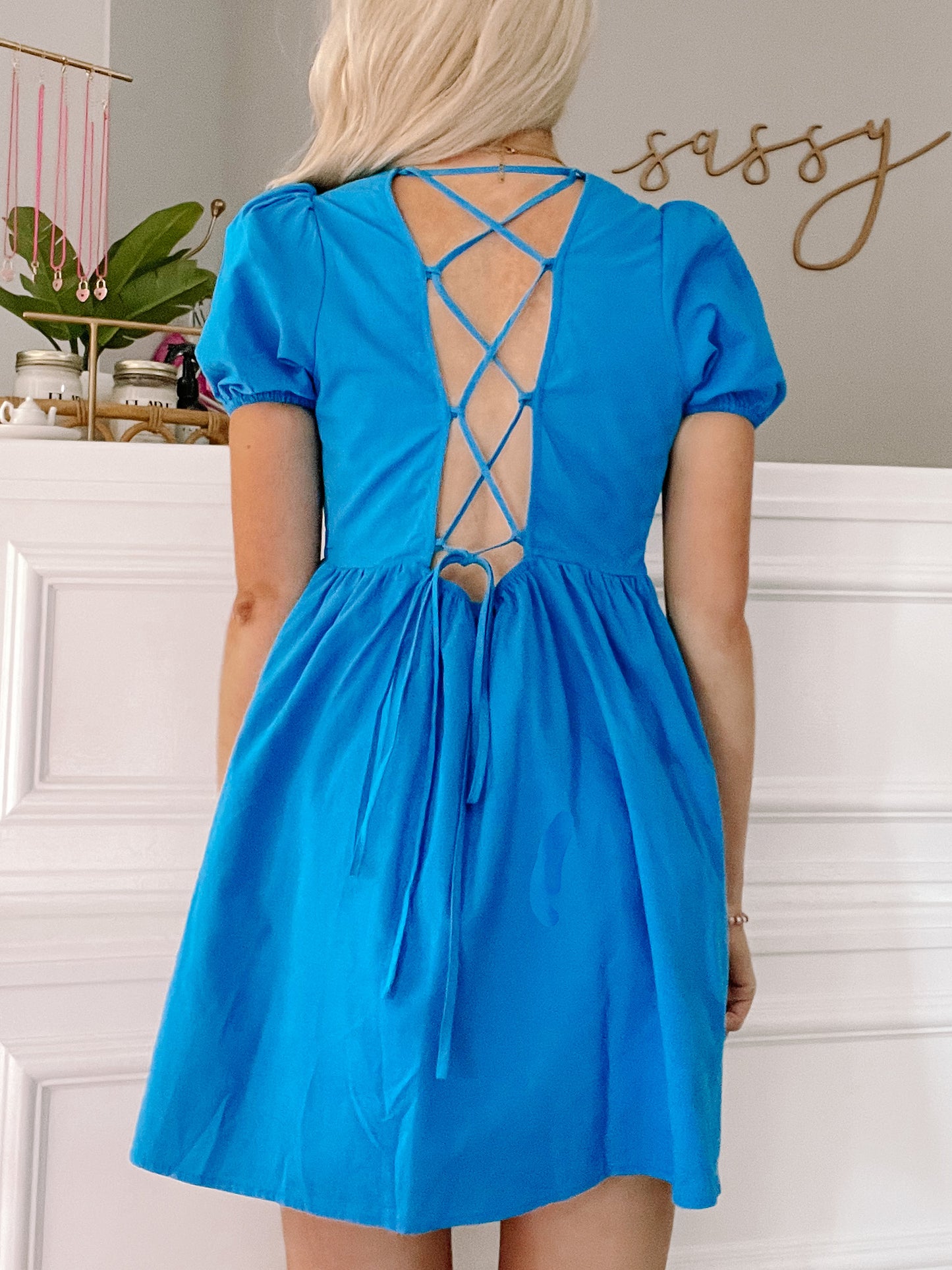 Electric blue mini dress with puff sleeves and a lace-up back detail.
