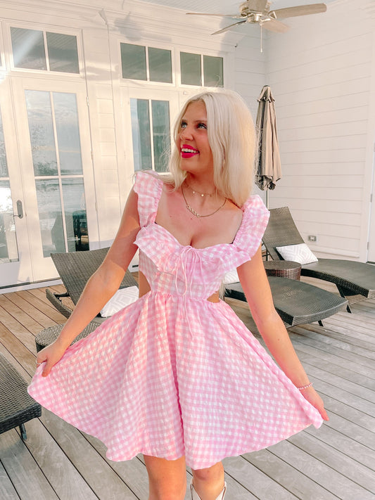 Pink gingham dress outdoors on a patio.