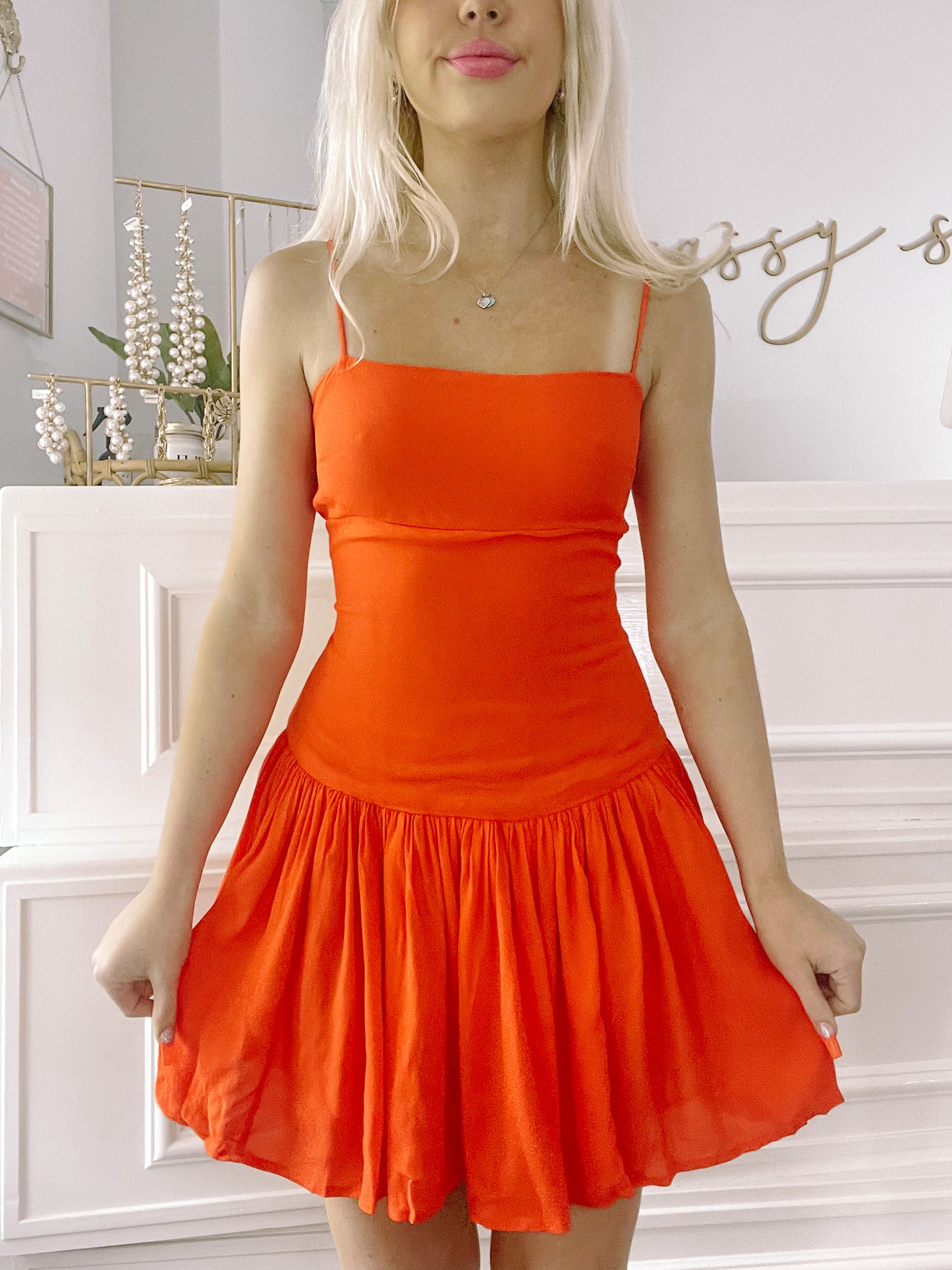 Bright orange Slice n Dice mini dress with a fitted bodice and a tiered skirt.