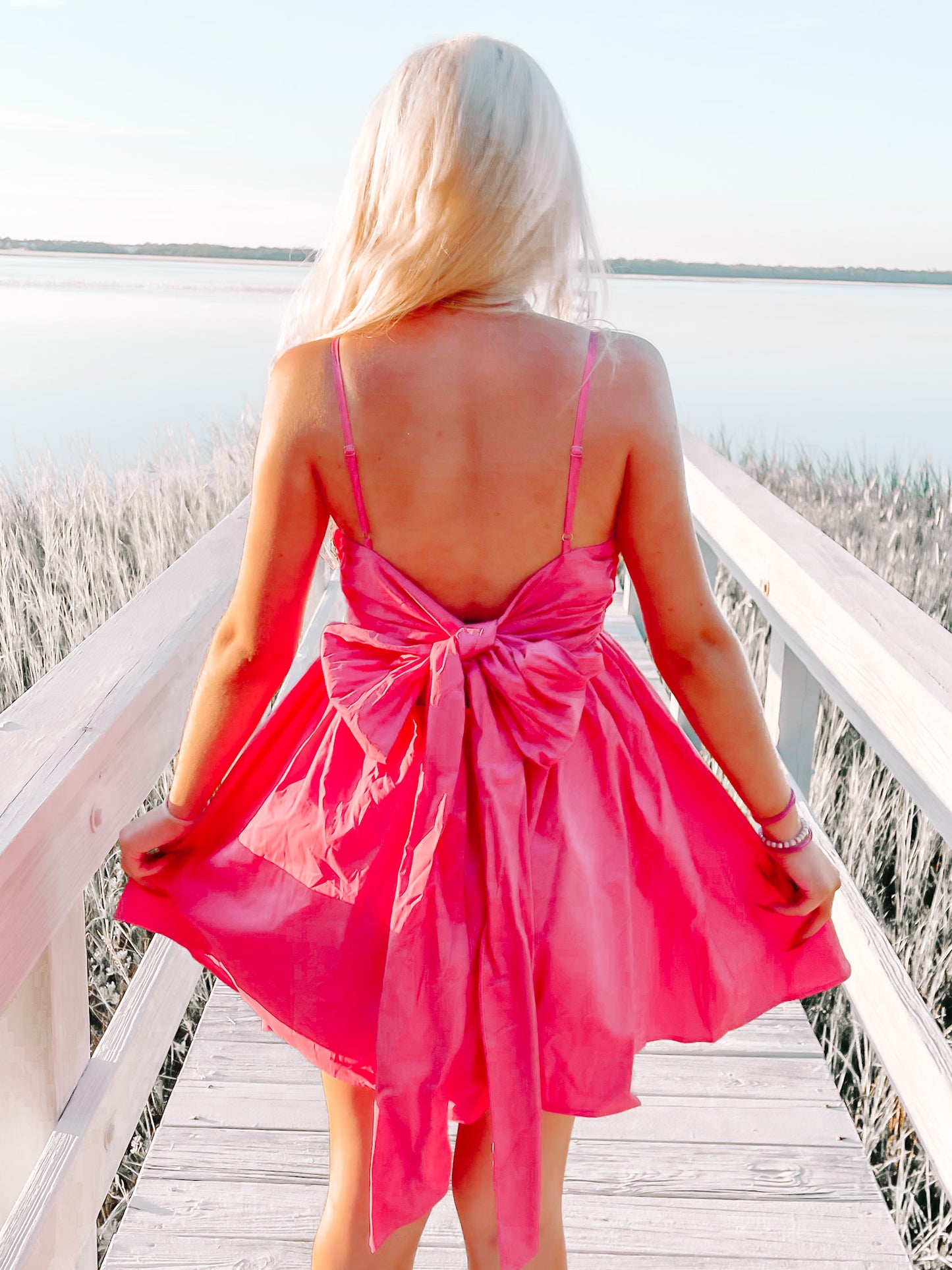Pink Bow Tide dress with large bow detail in the back.