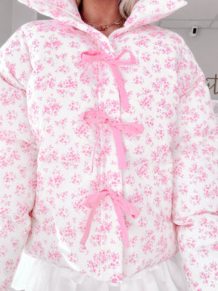 Pink floral puffer jacket with cute pink ribbon detailing.