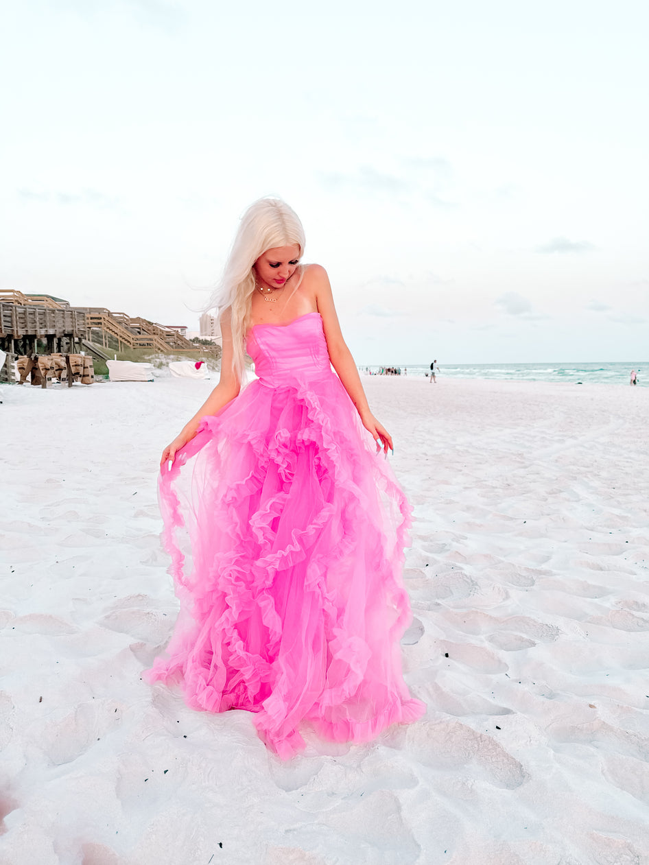 Pink tulle maxi dress on a beach.