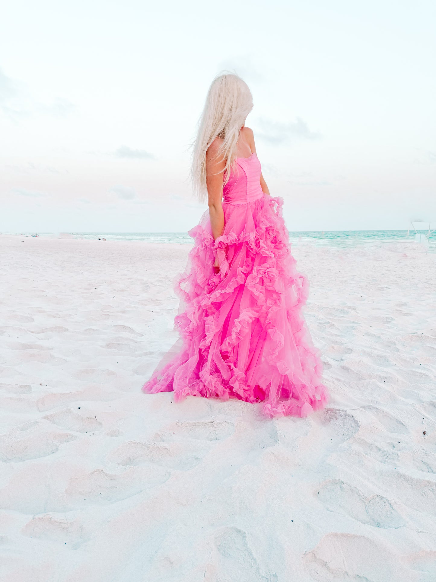Pink tulle dress on a beach.