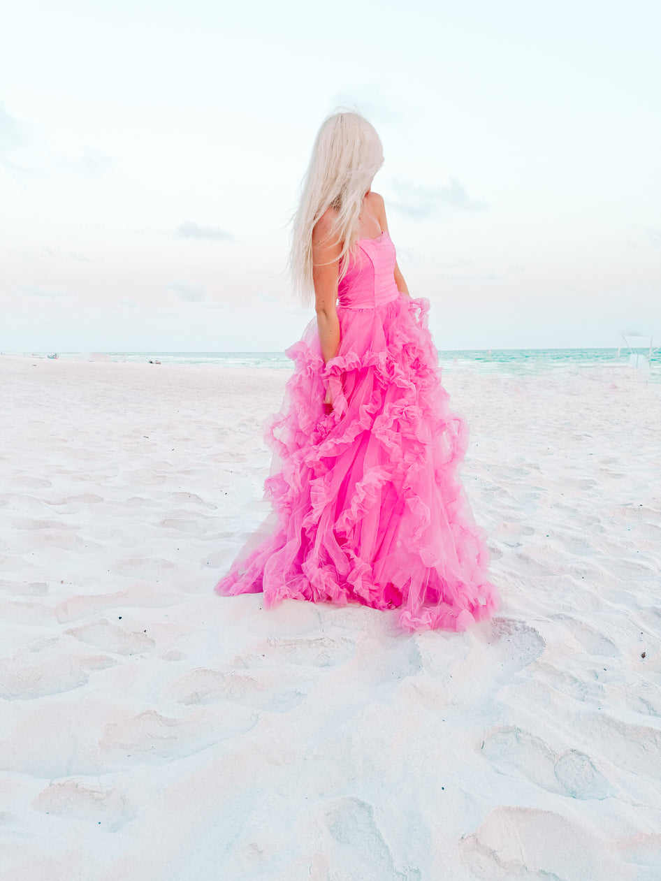 Pink tulle dress on a beach.