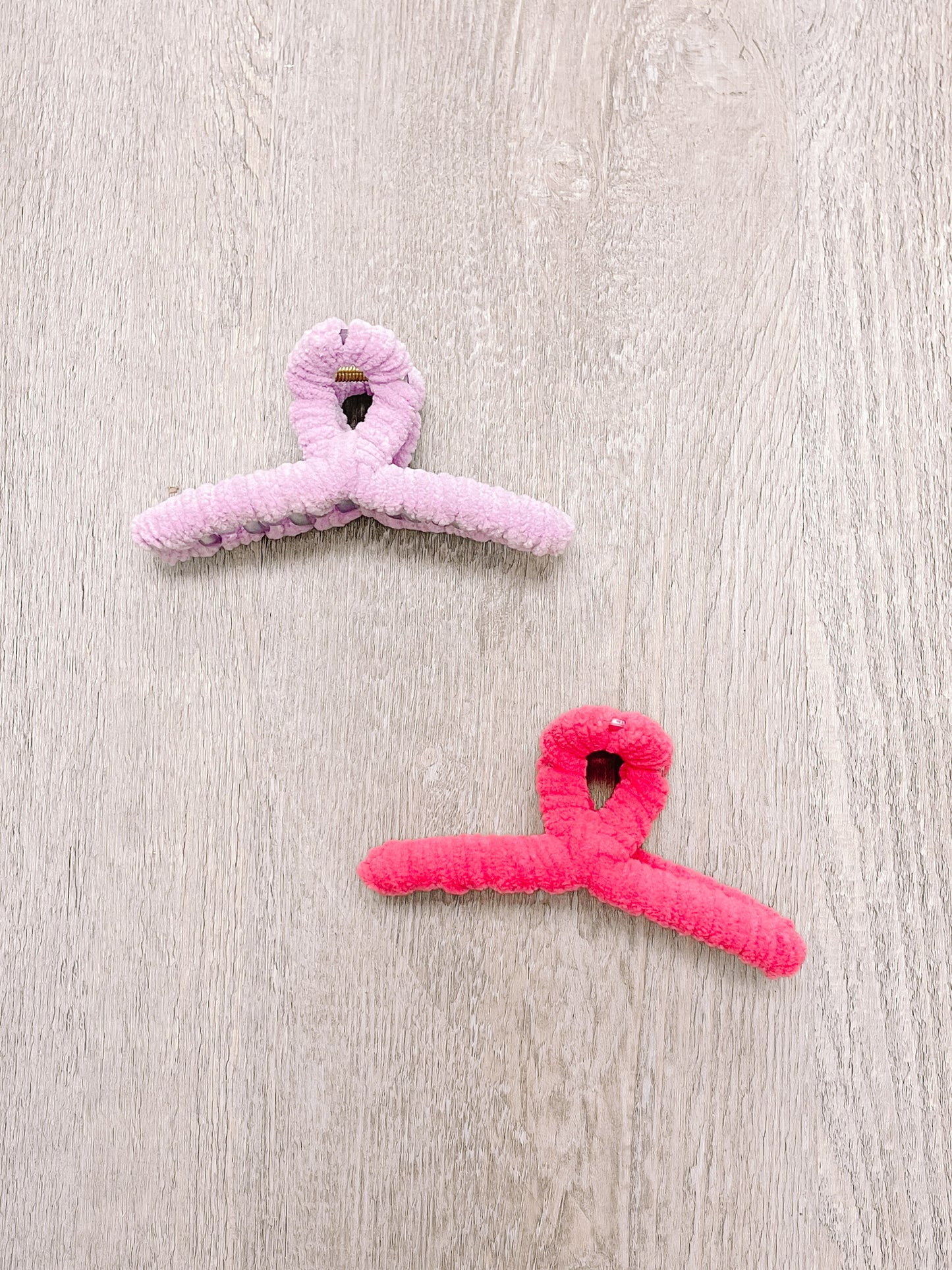 Fuzzy claw clips, pink and coral, soft velvet texture.