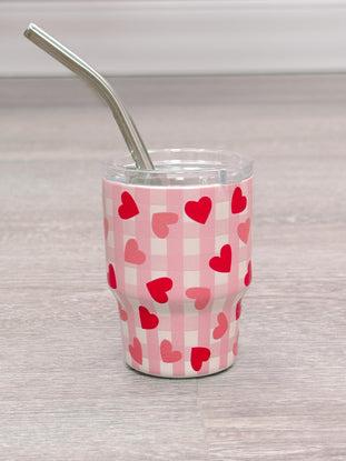 Pink tumbler with hearts and gingham print, includes stainless steel straw.