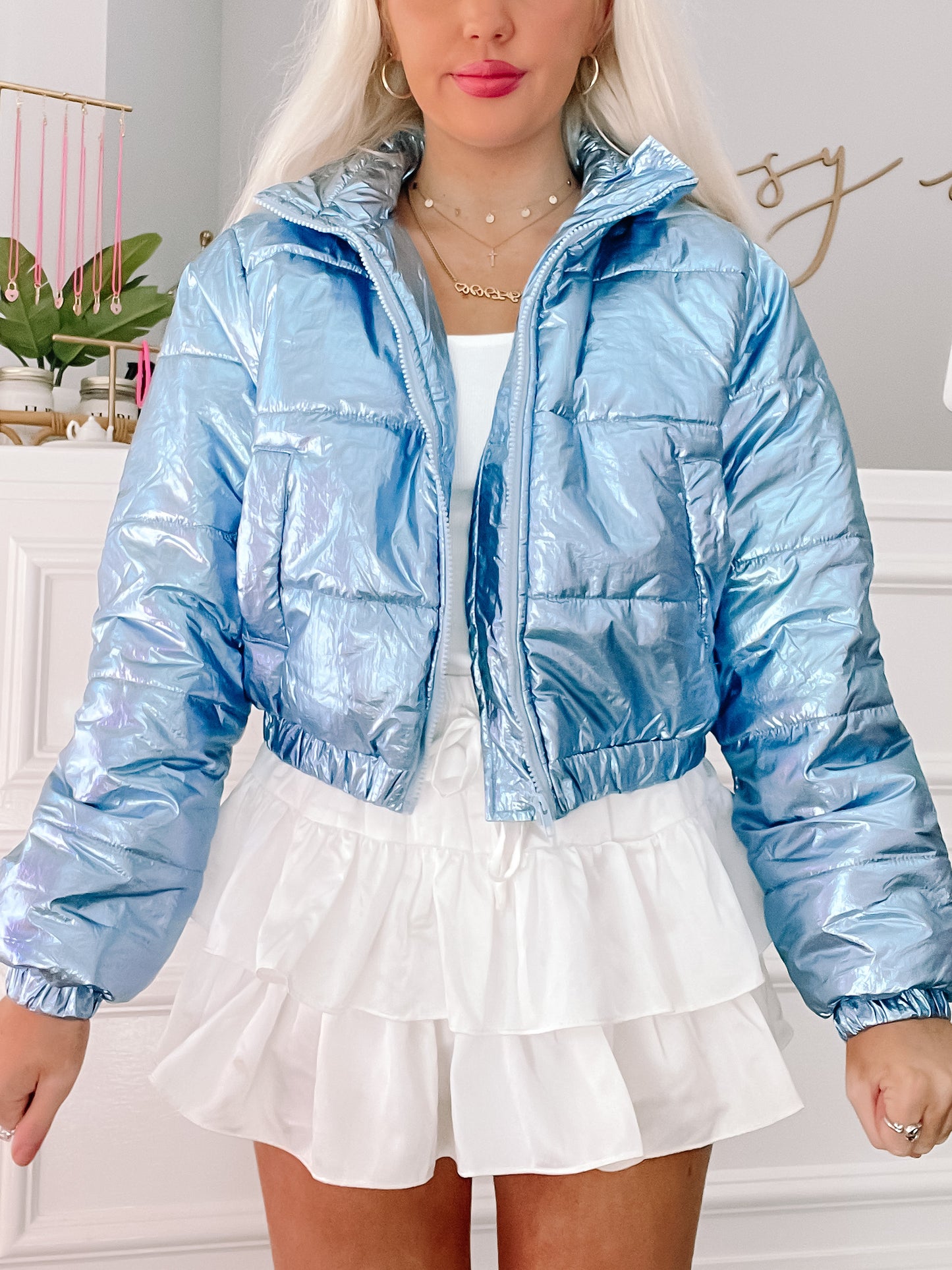 Metallic blue puffer jacket, cropped style.