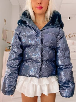 Sequin puffer jacket with faux fur trim, shown on model.