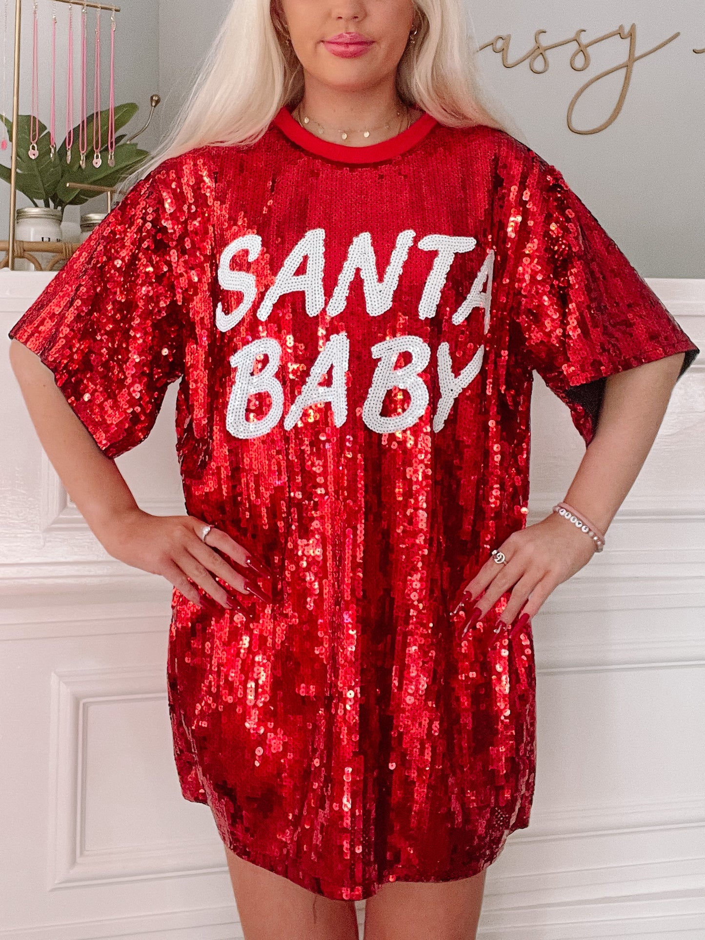 Red sequin mini dress with "Santa Baby" lettering; festive holiday apparel.