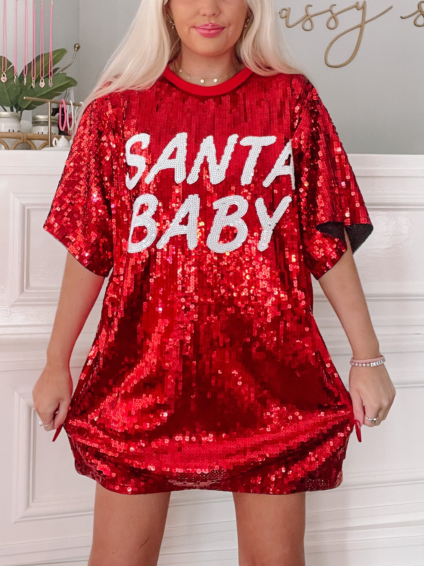 Red sequin mini dress with "Santa Baby" lettering; festive holiday apparel.