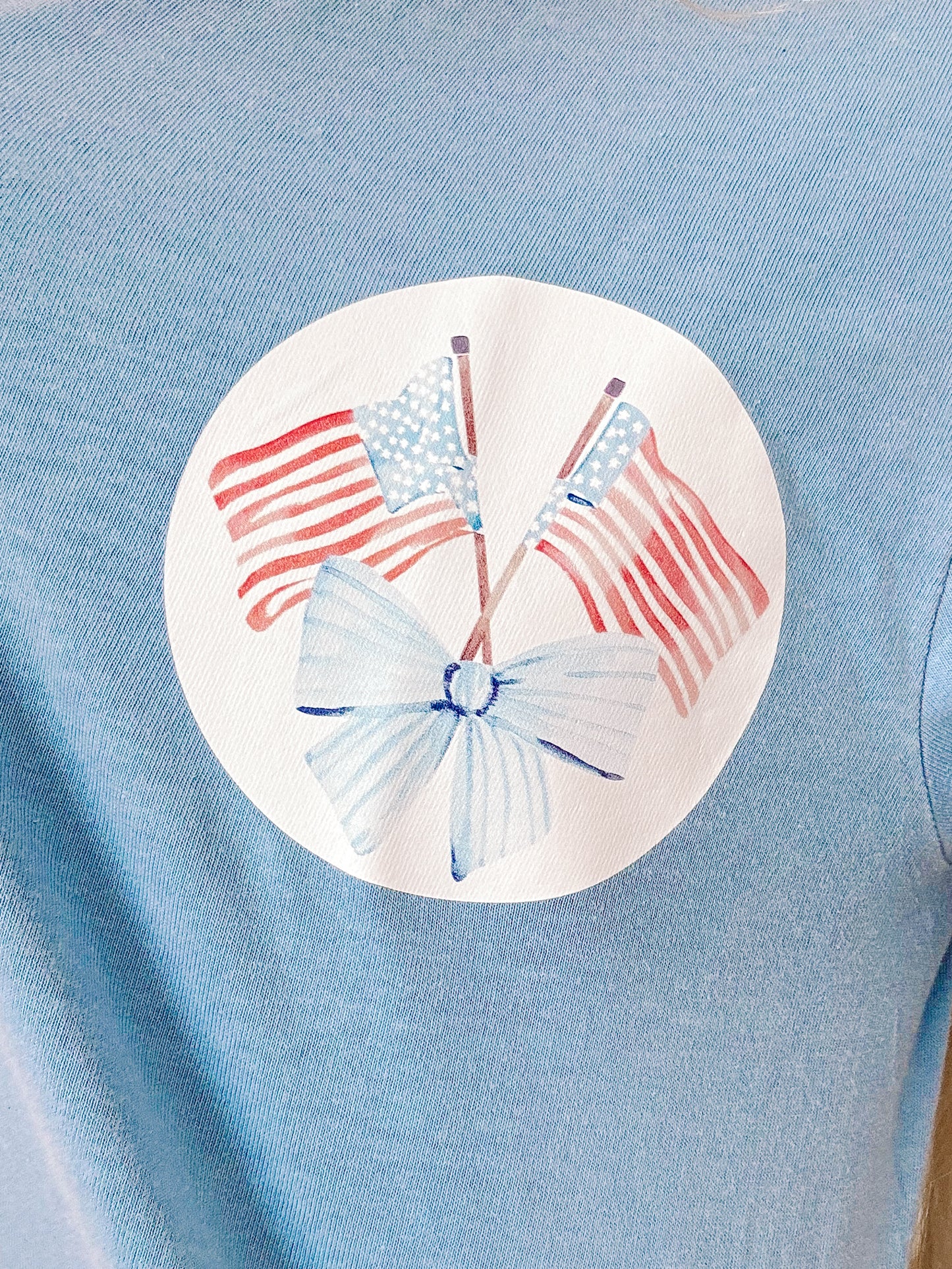 Close-up of bold graphic text and relaxed neckline on blue Sassy Shortcake tee.