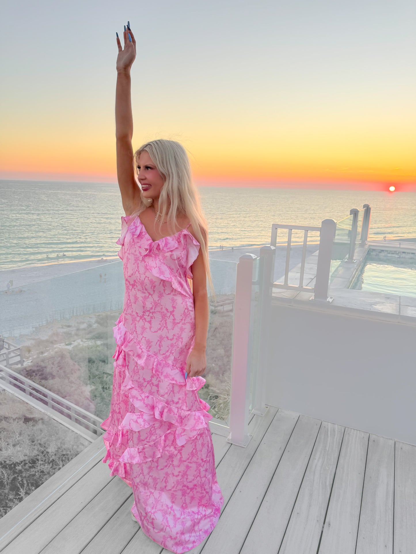 Pink ruffle maxi dress at sunset ocean view