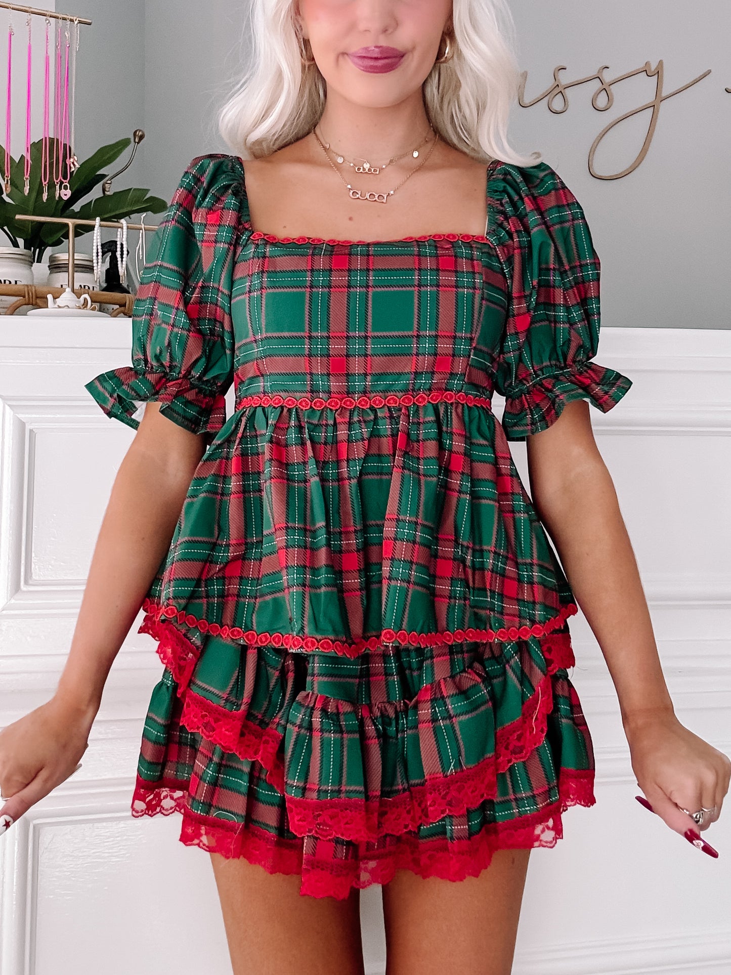 Green and red plaid top with puff sleeves and layered ruffle trim.