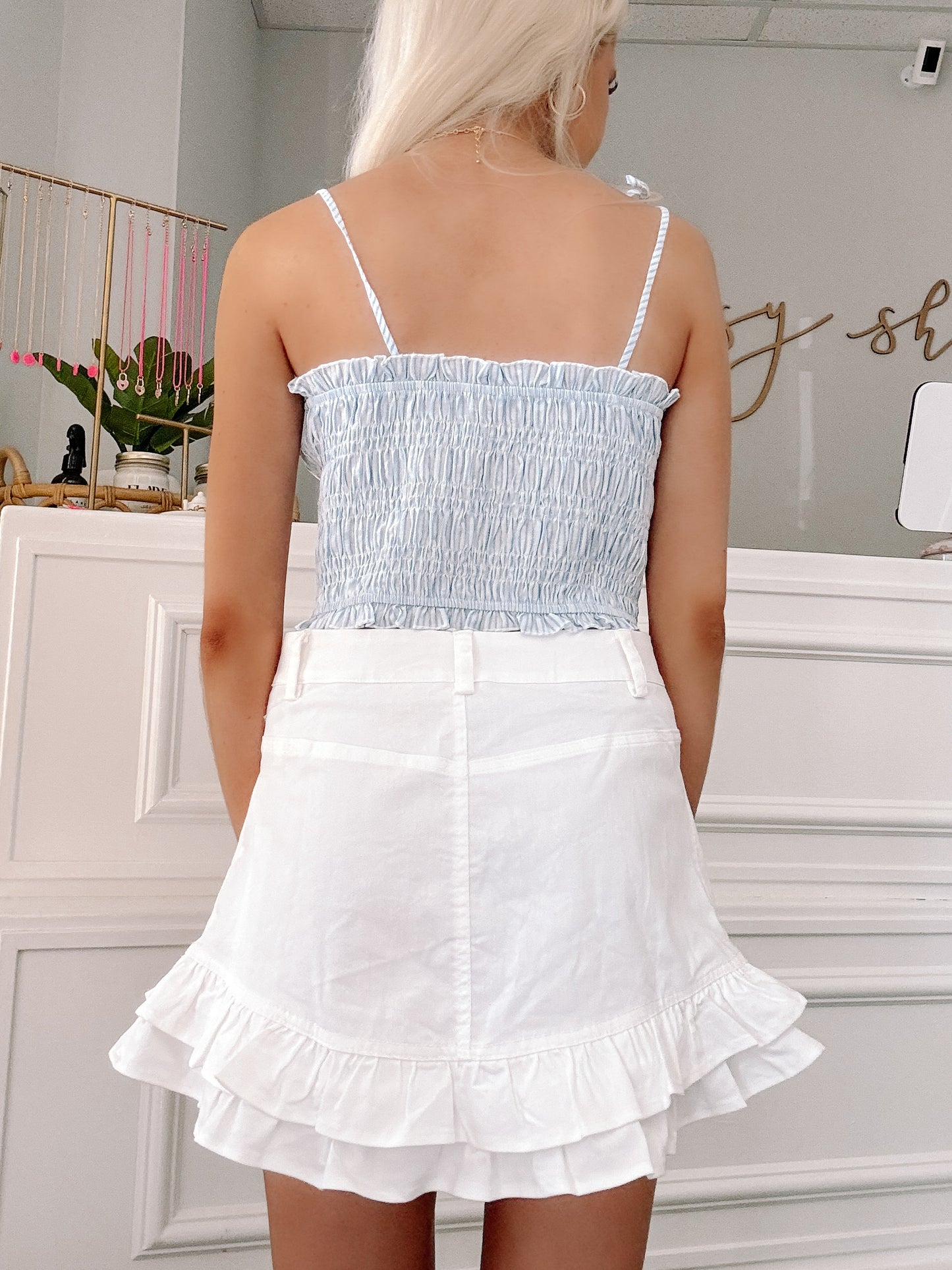 back view of the smocked view seersucker top
