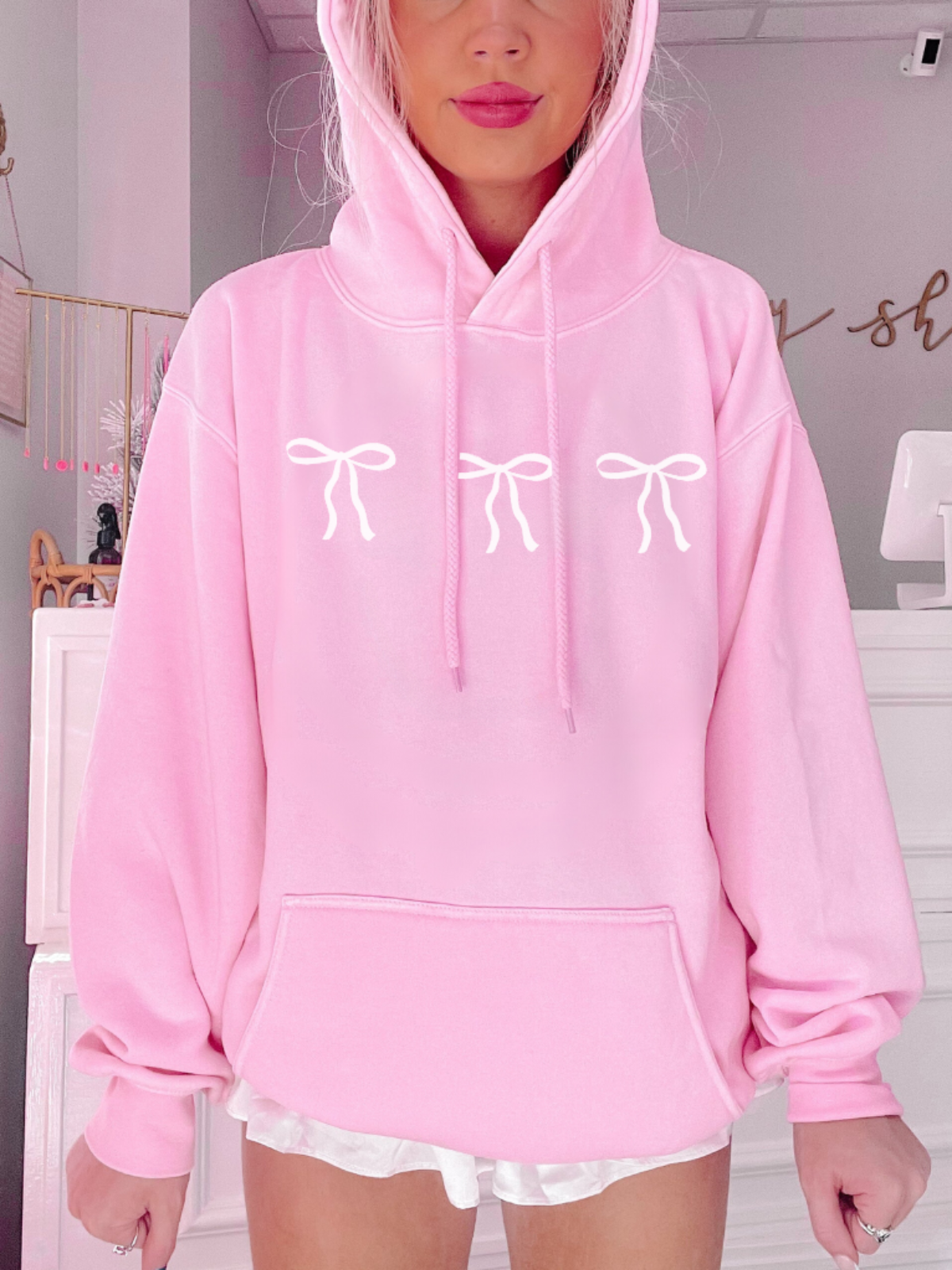 Pink Blushing Bow Hoodie with three white bow details. Pink Bow Sweatshirt from Sassy Shortcake