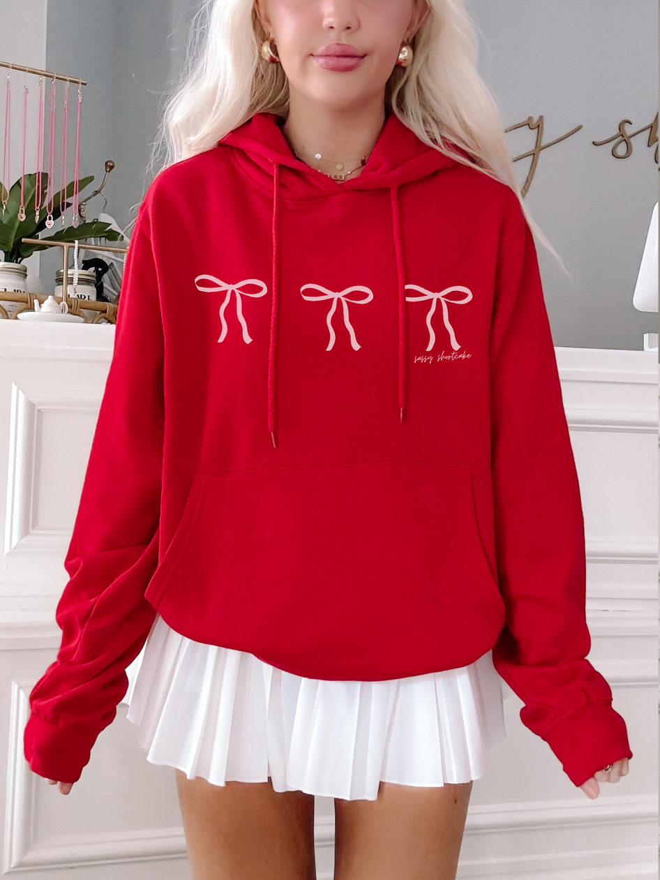 Red Blushing Bow Hoodie with three pink bows, comfy oversized fit.