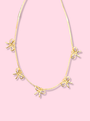 Gold Bow & Repeat necklace with four charming bow charms on a delicate chain.