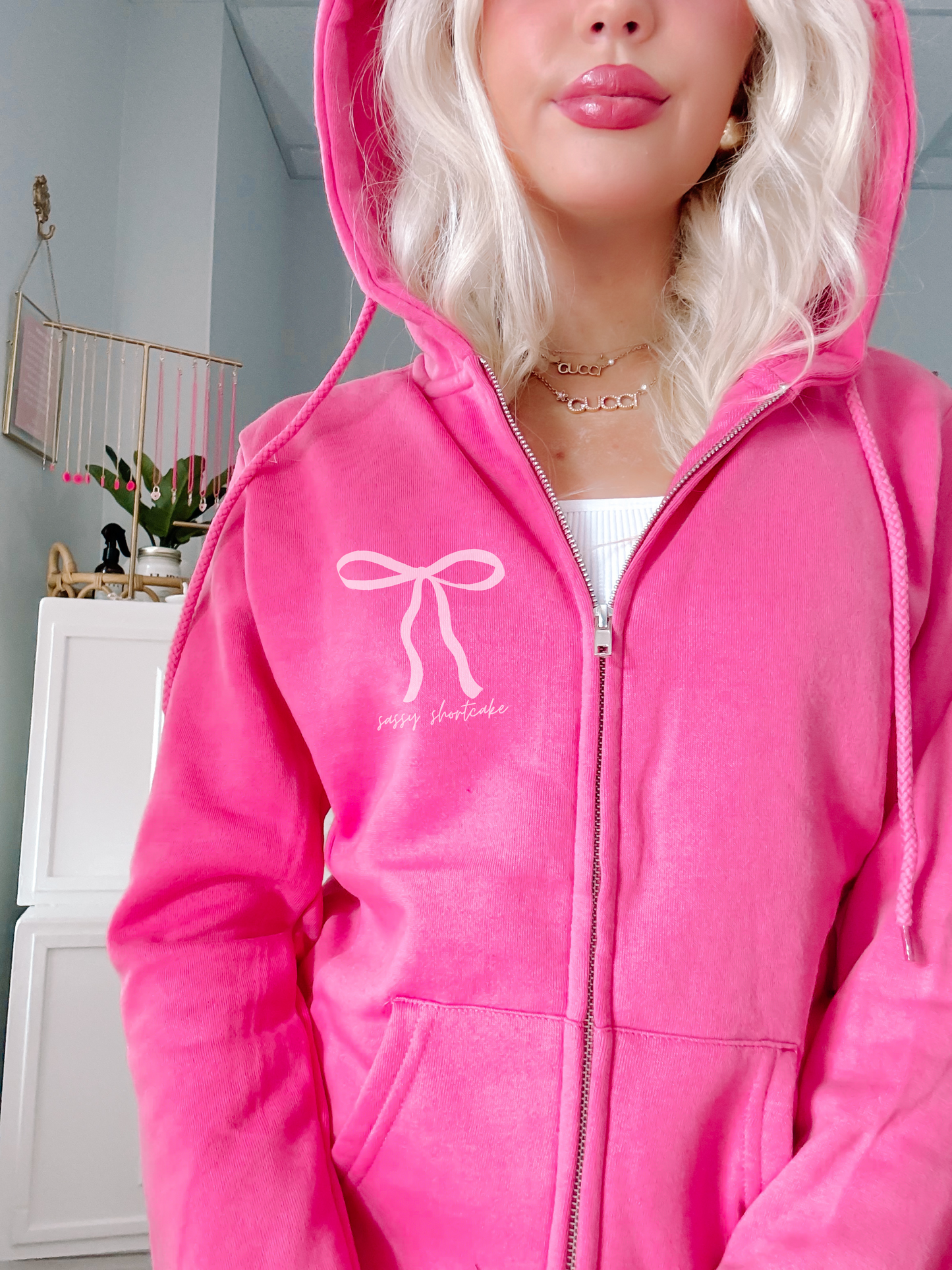 Hot pink zip-up hoodie featuring a bow design and "sassy shortcake" text.