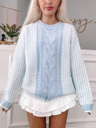 Breezy Blue Cable Knit Sweater: Pastel blue and white knit, featuring a cable knit detail.