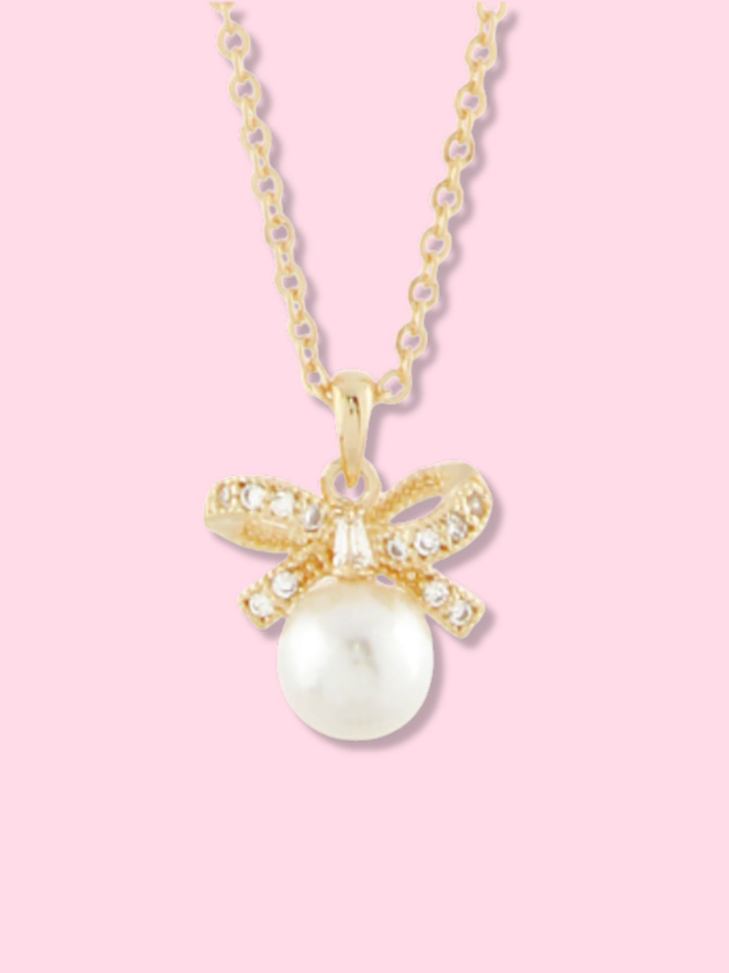 Gold Dainty Darling Bow Necklace with pearl and cubic zirconia accents.