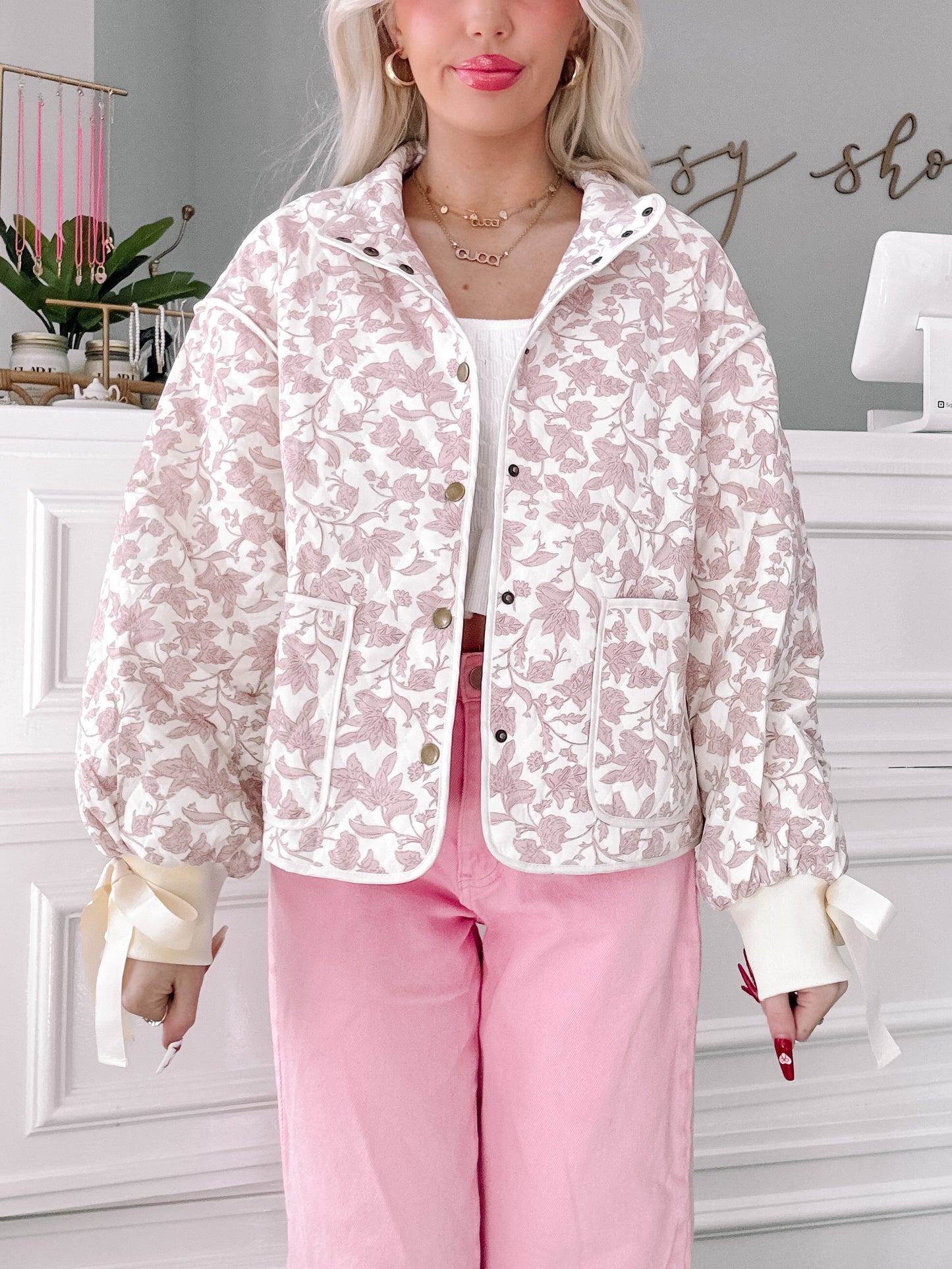 Floral Daydream quilted jacket in blush pink floral print with button front and ribbon-tied cuffs.
