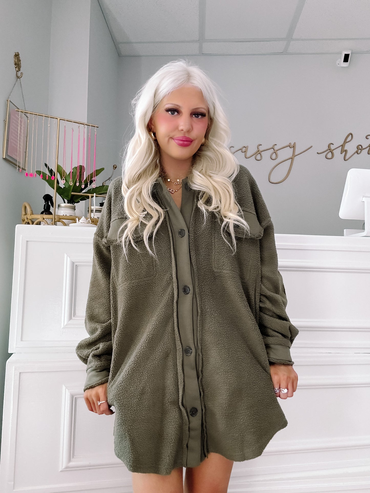Olive green fleece shacket styled in a boutique.