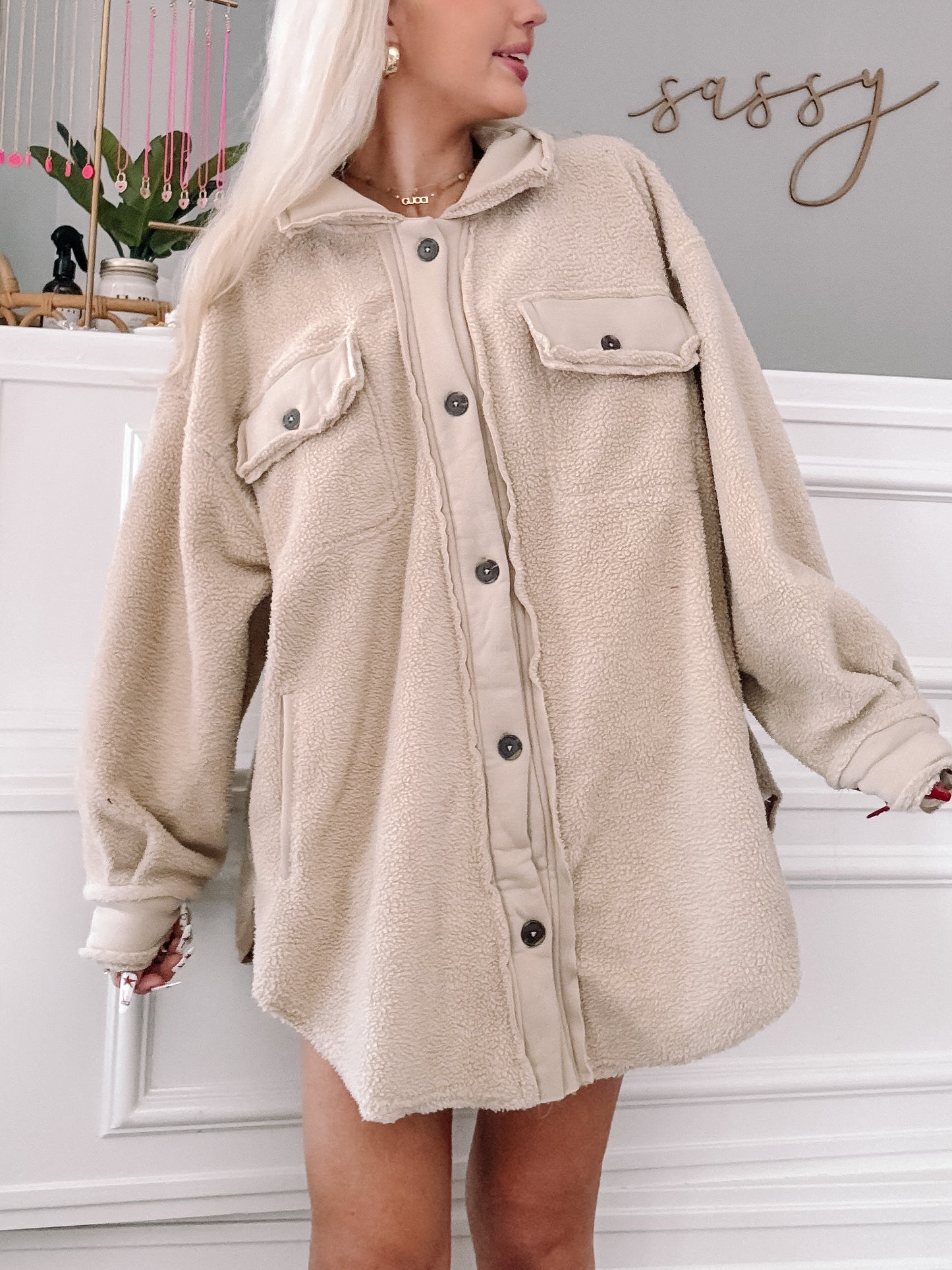 Cream-colored fuzzy shacket styled on a model, showcasing its cozy texture and oversized fit.