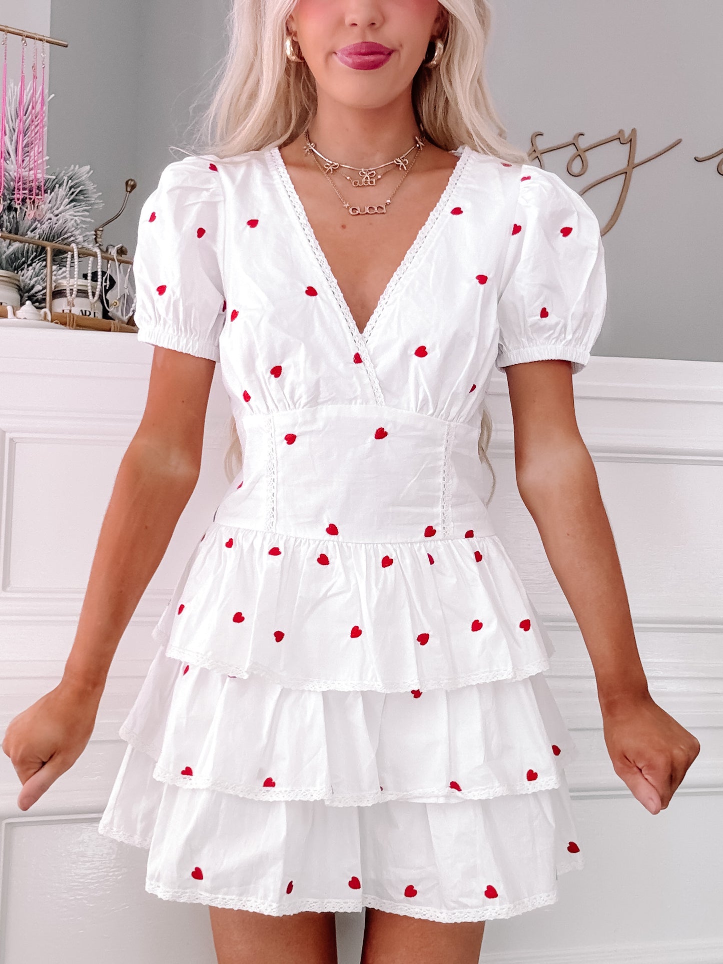 Hearts Desire Dress: White tiered mini dress with embroidered red hearts and lace trim.