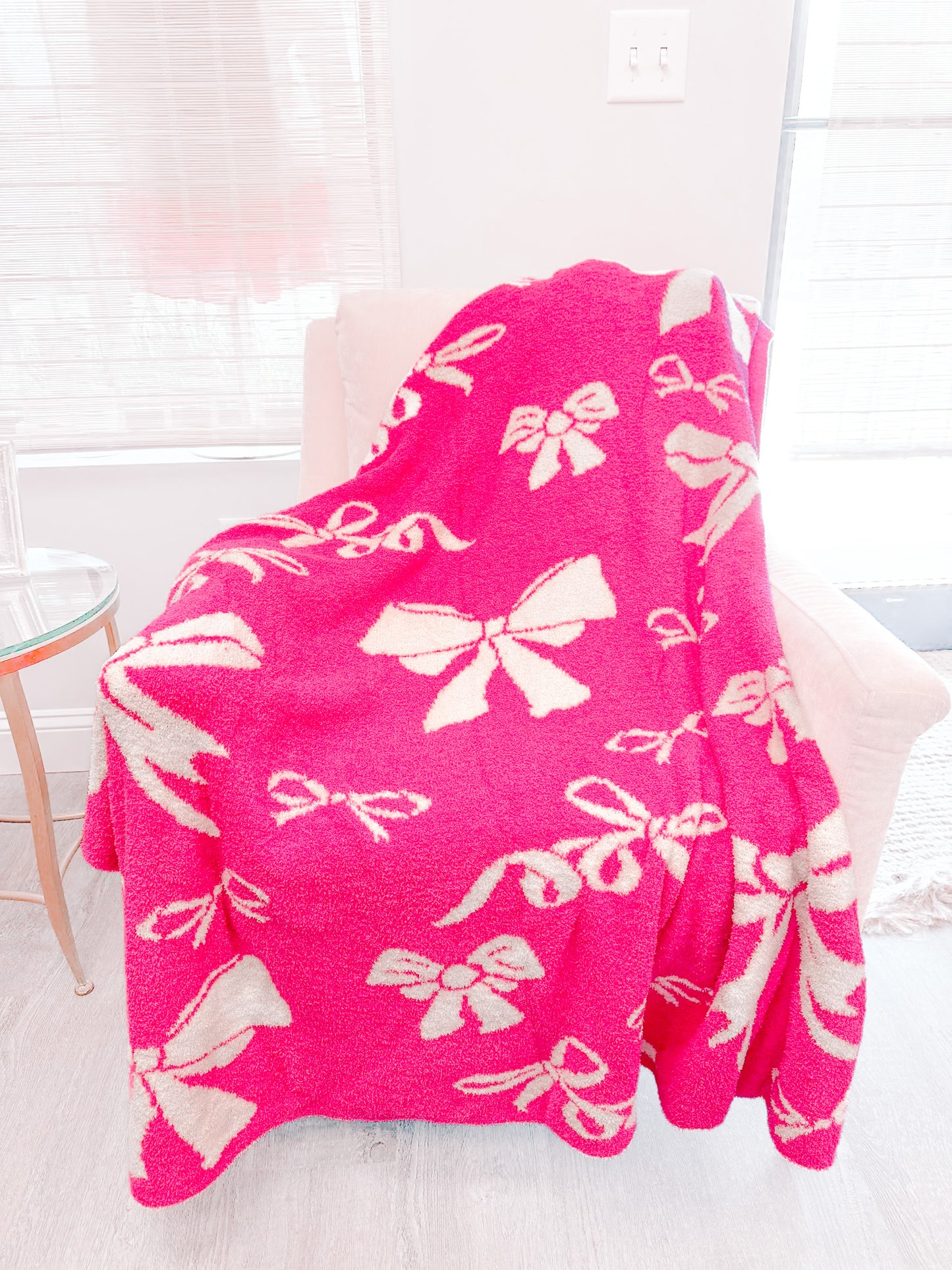 Hot pink Bow Blanket with cream bow pattern, cozy plush texture.