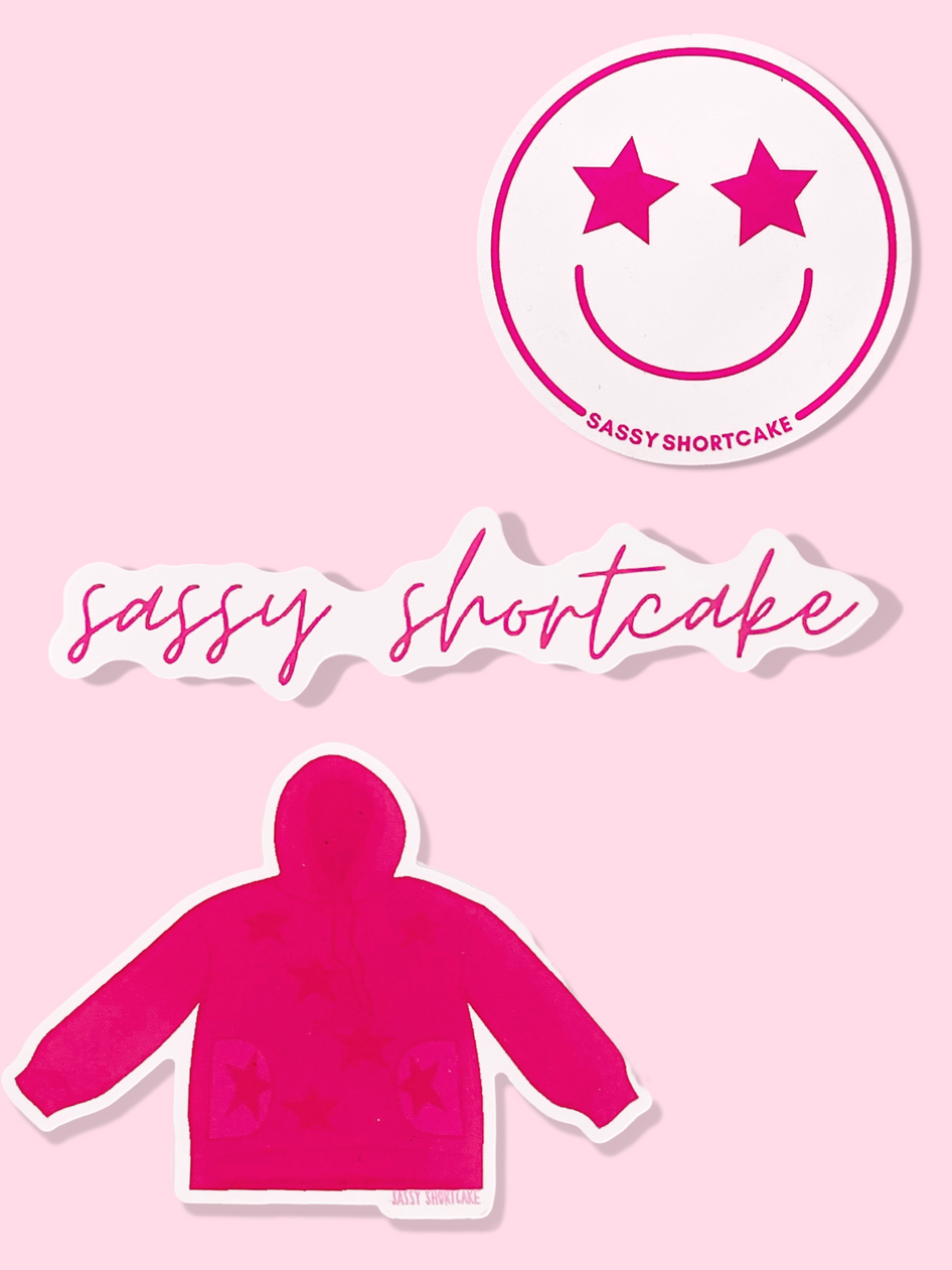 Sassy Shortcake sticker pack: 3 pink & white stickersโsmiley face, script logo, & star-print sweater.