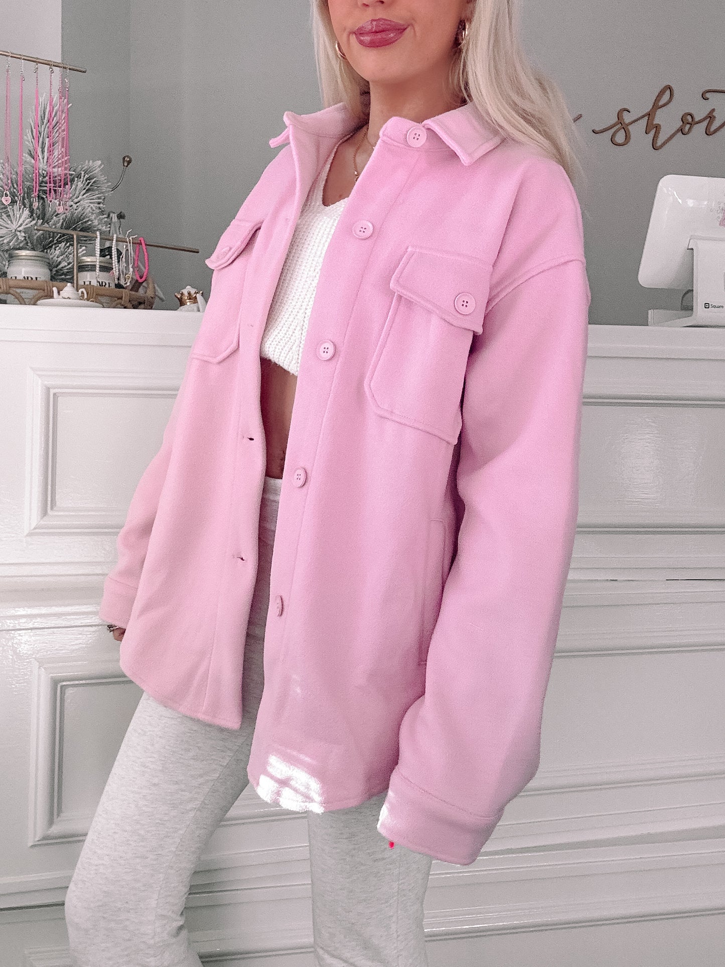 Lightweight pink shacket styled over a white top and grey bottoms.