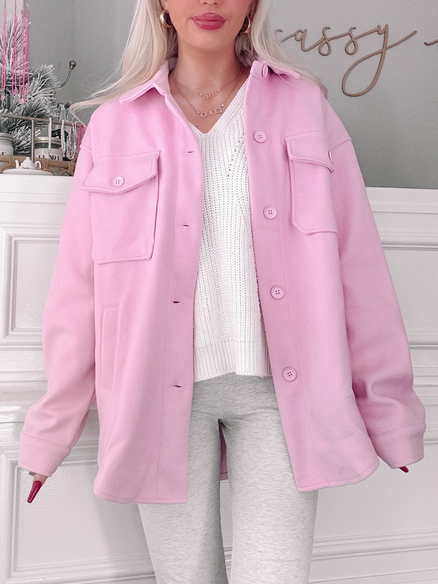 Pink shacket styled with a white sweater and gray leggings.