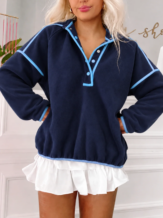 Front view of the Sassy Shortcake Ivy League Pullover snapped closed, showing the stand-up collar, light blue snaps, and piping.