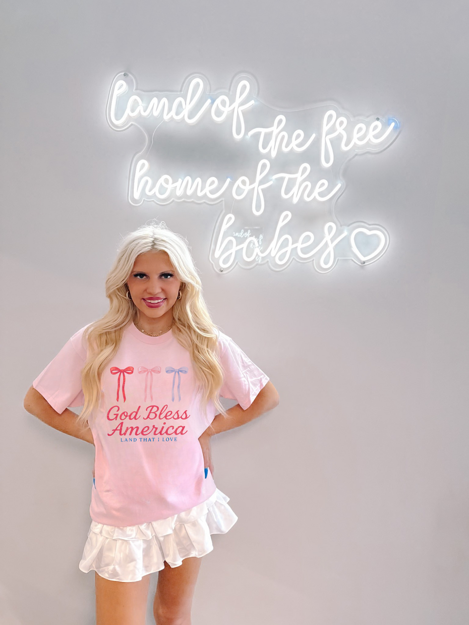 model wearing pink patriotic sassy shortcake bow tshirt