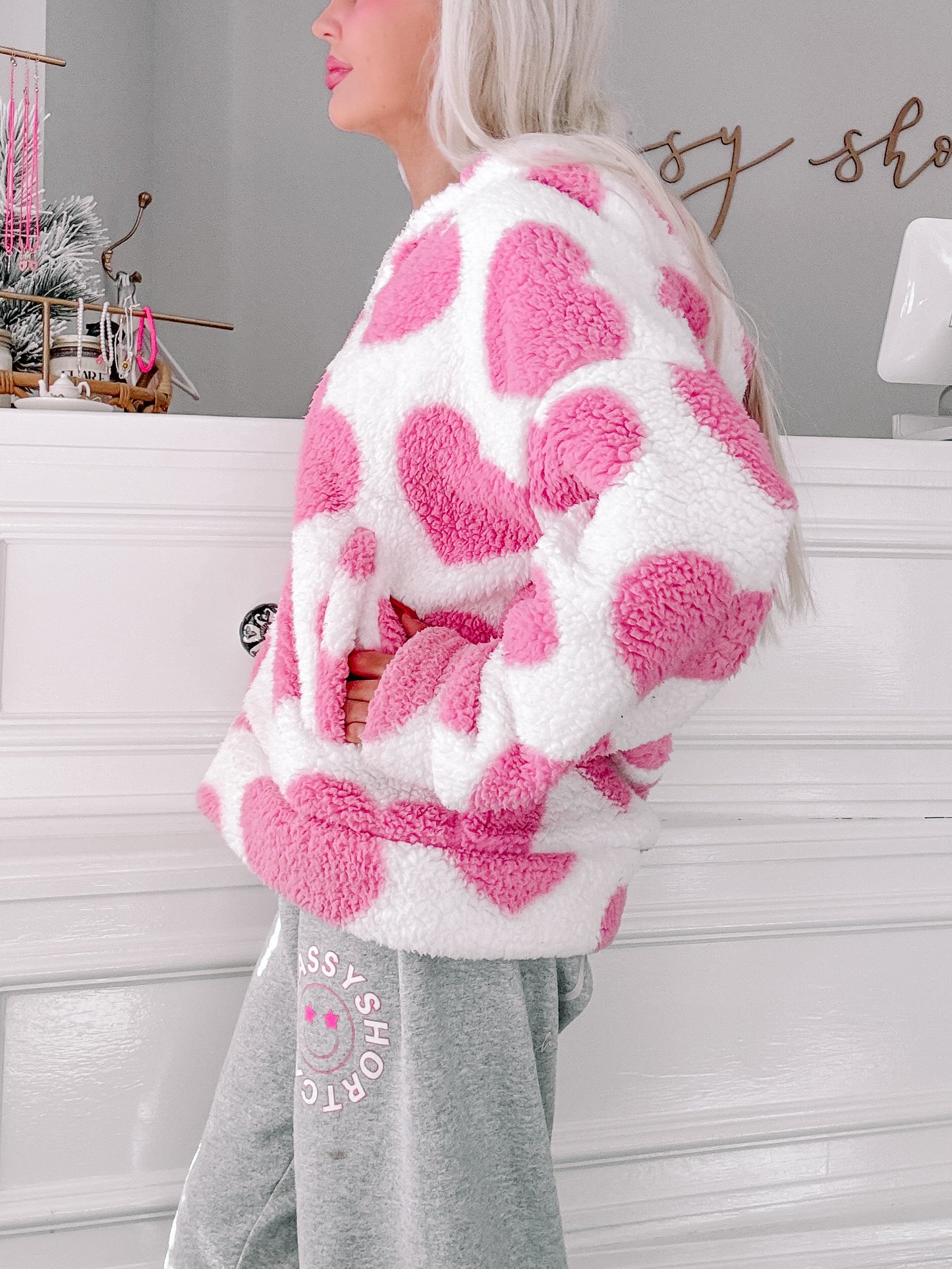 Pink and white heart-print sherpa jacket, soft and cozy.
