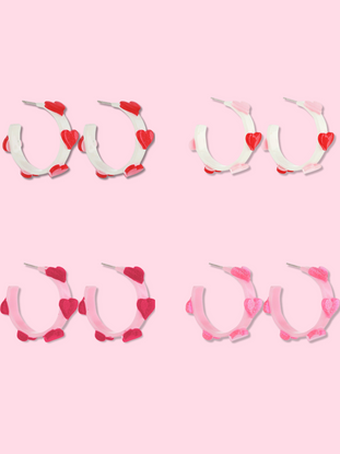 Pink and white heart-shaped hoop earrings; various styles.