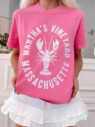 Oversized pink tee styled casually with coastal graphic print.