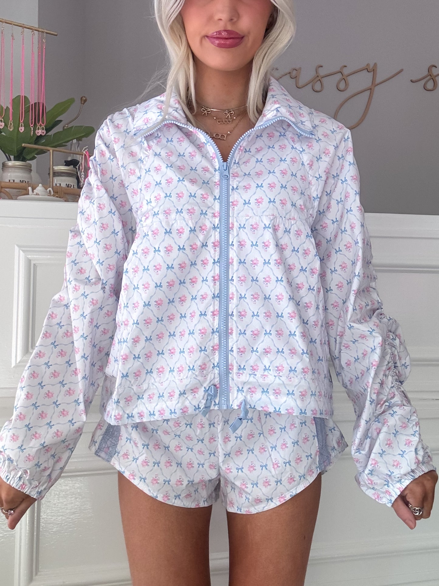 Floral-print shorts and matching jacket, light blue and pink pattern.