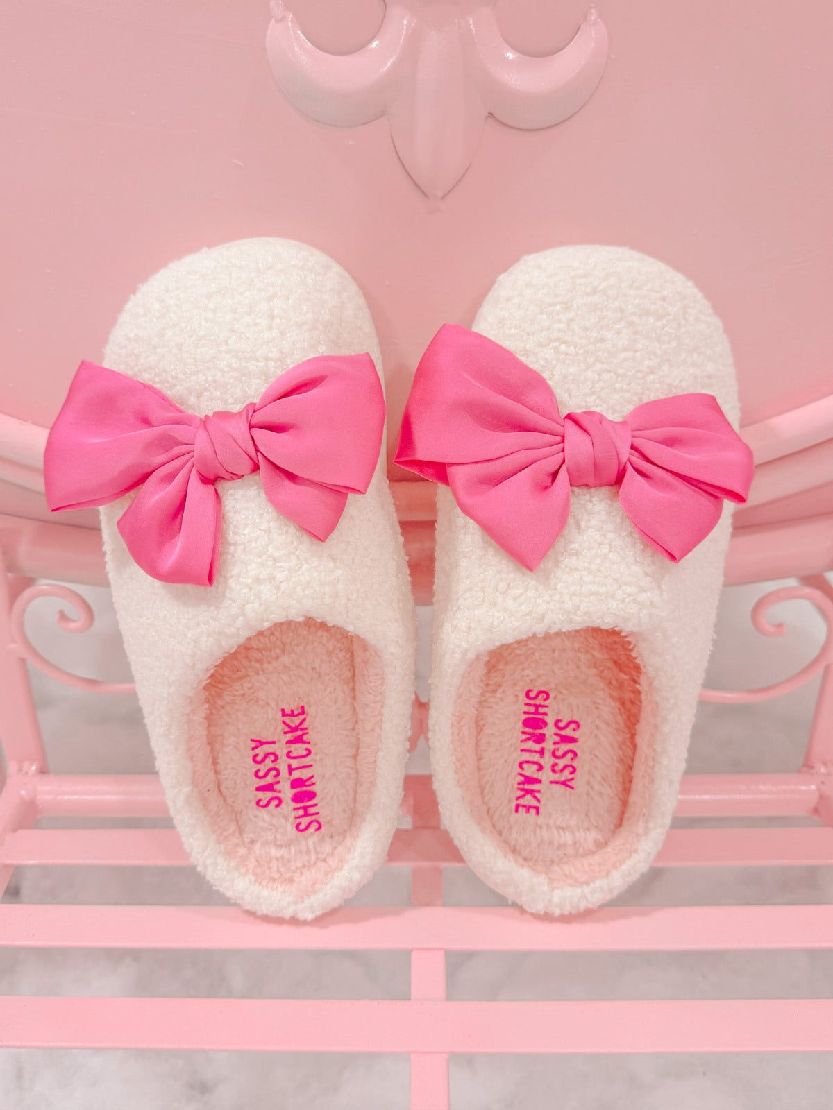 Satin Pink Bow Slippers by Sassy Shortcake – top view of cozy bow slippers in pastel pink preppy setup